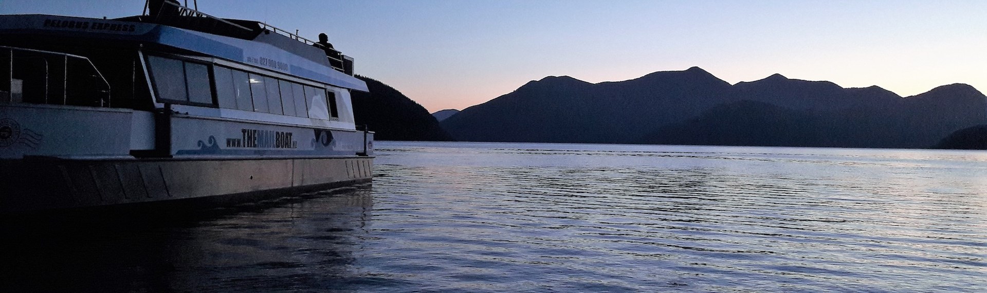 Pelorus Mail Boat at sunset in the water during a charter.